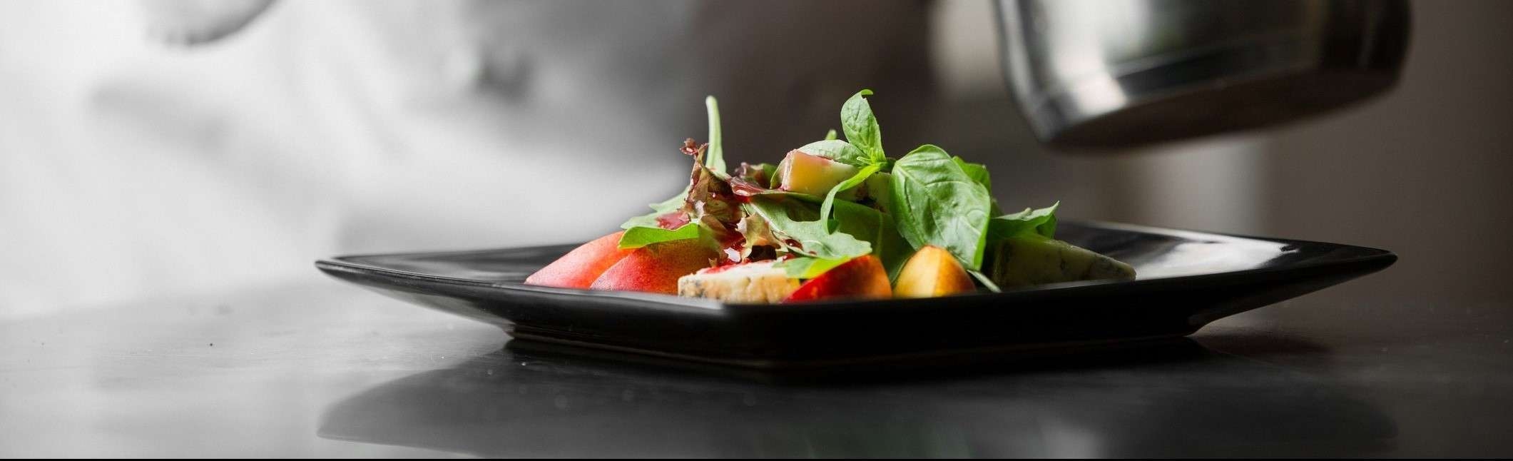 Chef prepping a plate of food