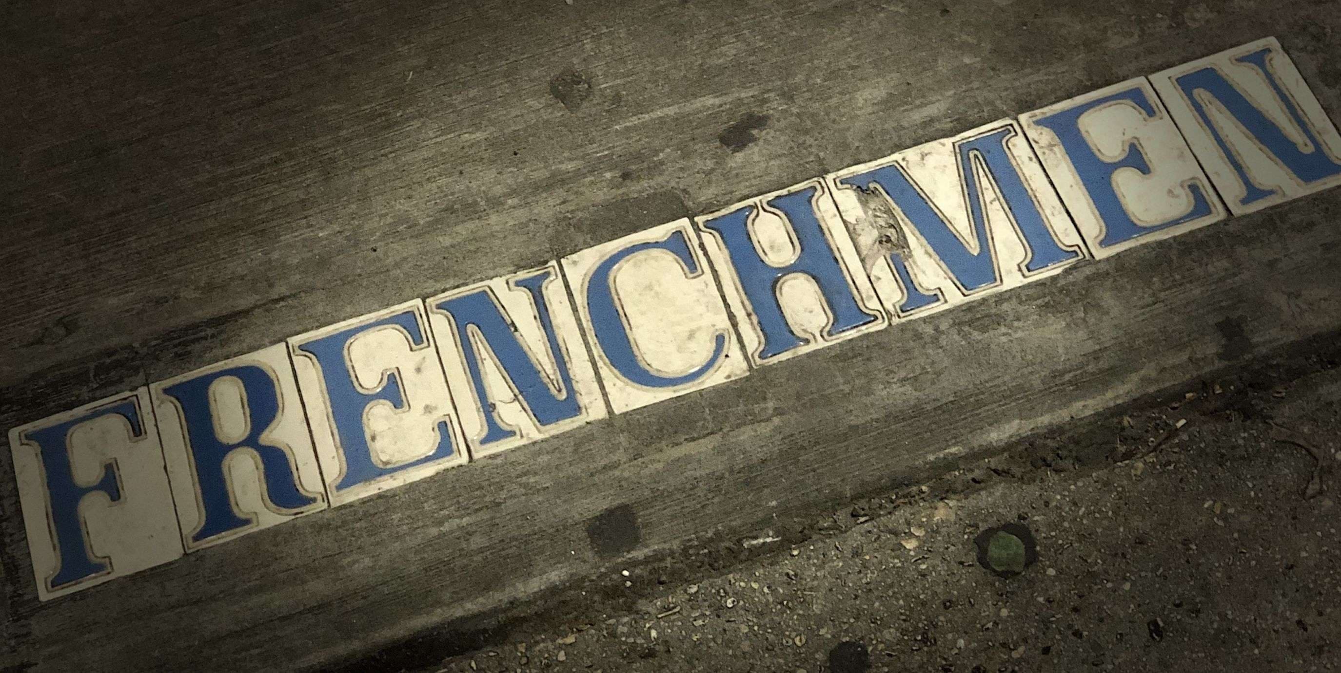 Sidewalk along Frenchmen Street bearing the street name