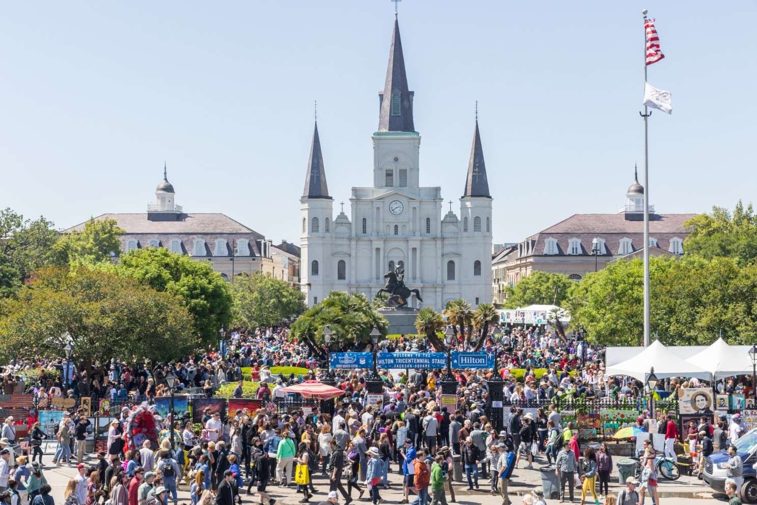 People running through the French Quarter in front of Jackson Square