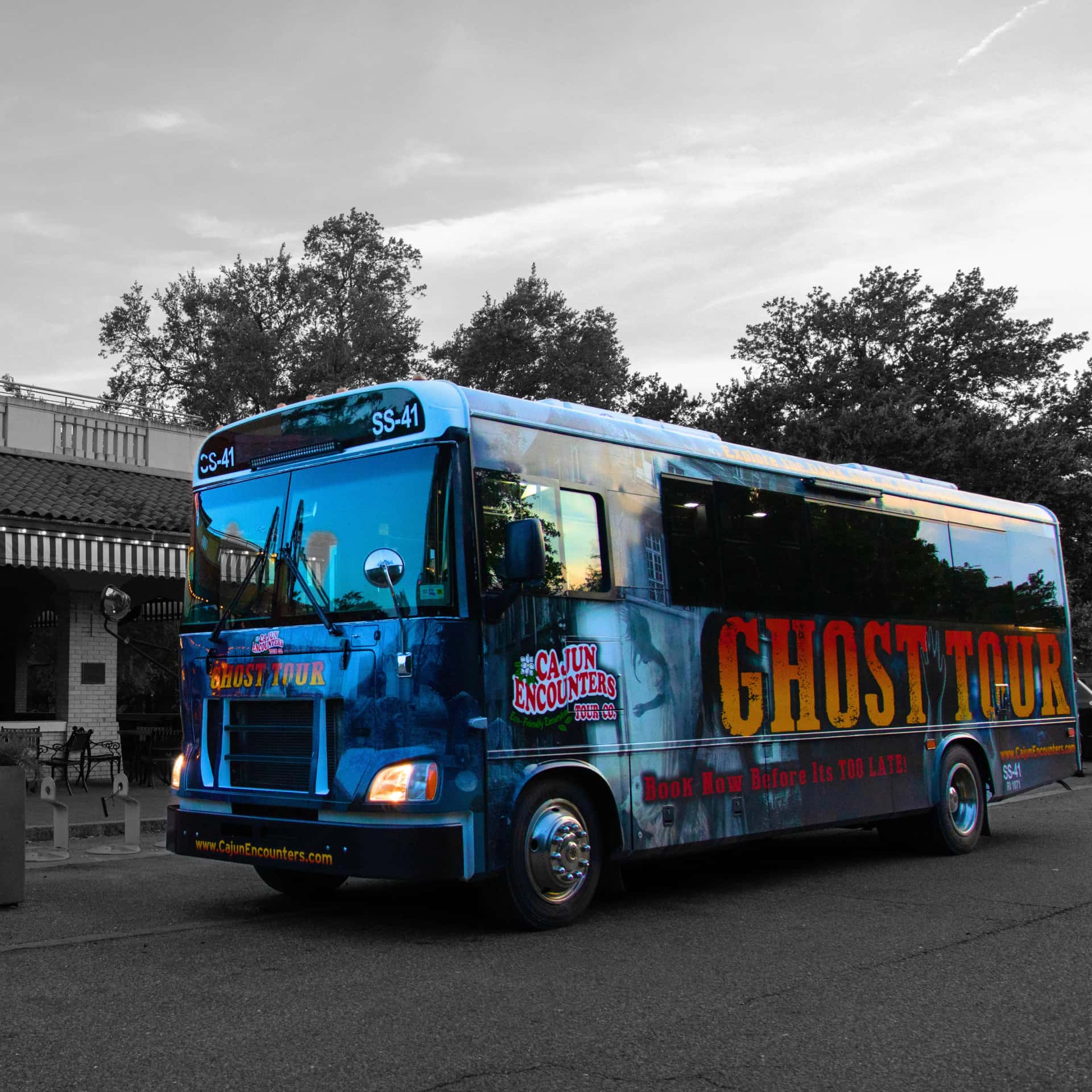 A New Orleans tour bus painted blue and decorated for Cajun Encounters' New Orleans Ghost Bus Tour.