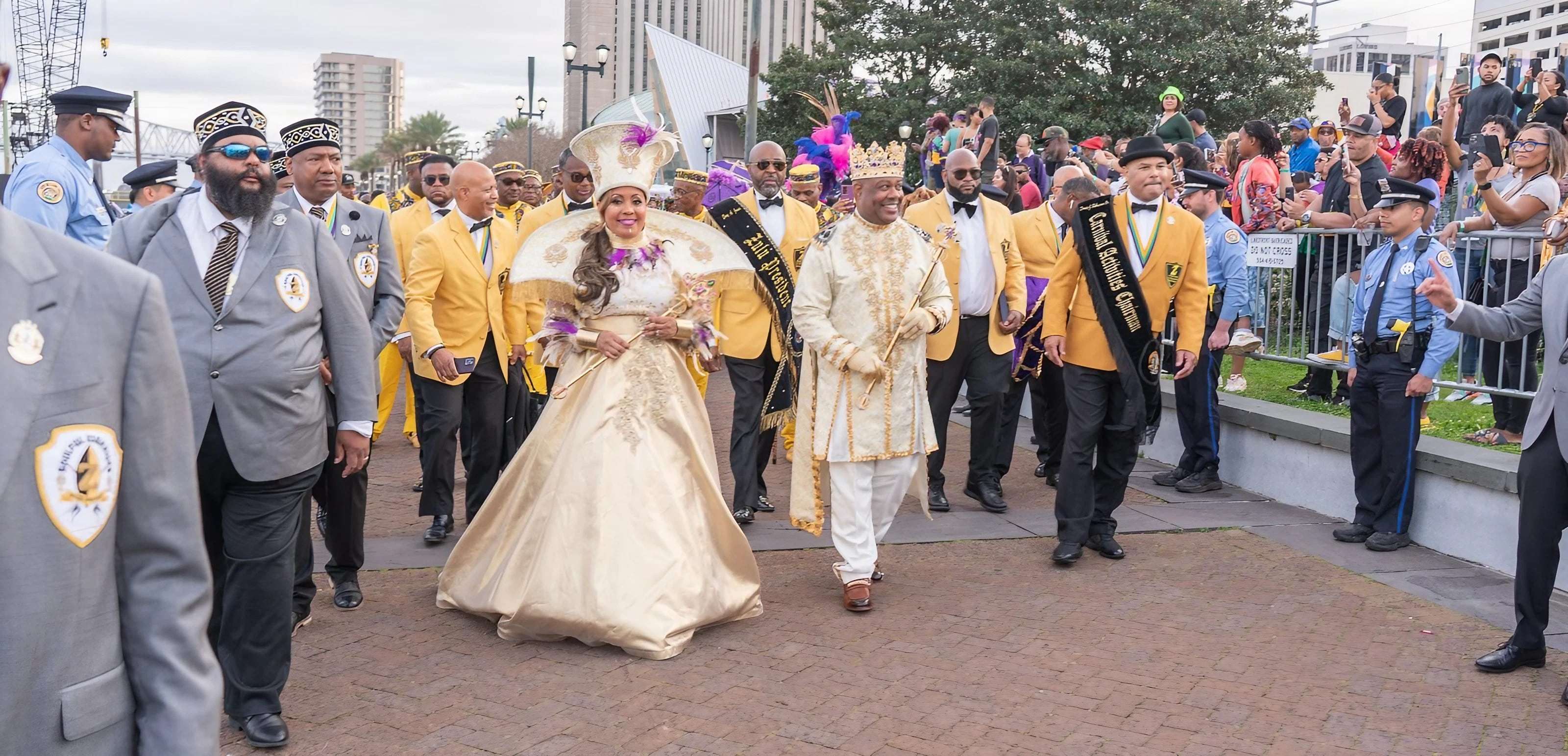 King and Queen of Zulu Lundi Gras Festival walking in a parade with other Zulu Krewe members